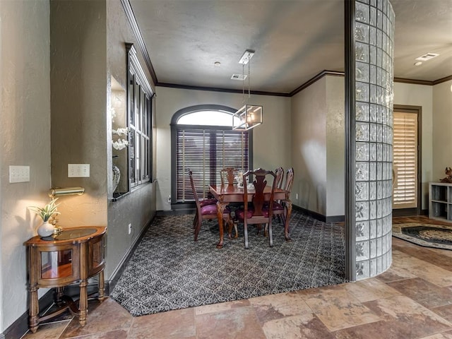 9408 S Caldwell Dr, Midwest City, OK 73130 - dining room with ornamental molding, a chandelier, baseboards, a textured wall, and stone finish flooring
