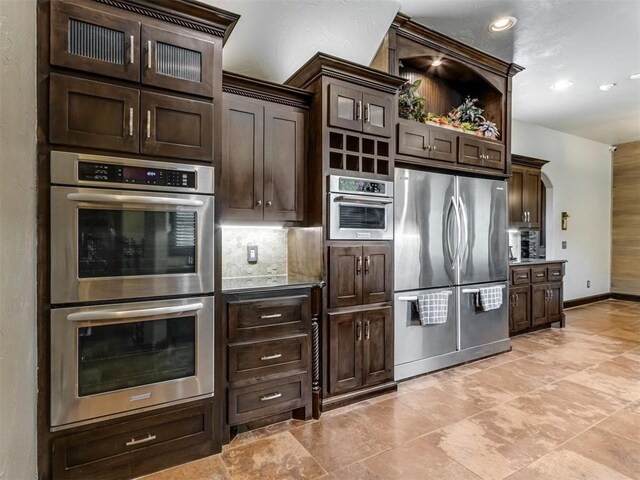 9408 S Caldwell Dr, Midwest City, OK 73130 - kitchen featuring stainless steel appliances, decorative backsplash, dark brown cabinetry, and recessed lighting