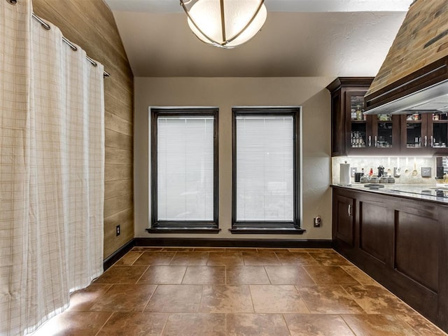 9408 S Caldwell Dr, Midwest City, OK 73130 - indoor bar with vaulted ceiling, baseboards, dark stone finish floors, custom exhaust hood, and healthy amount of natural light