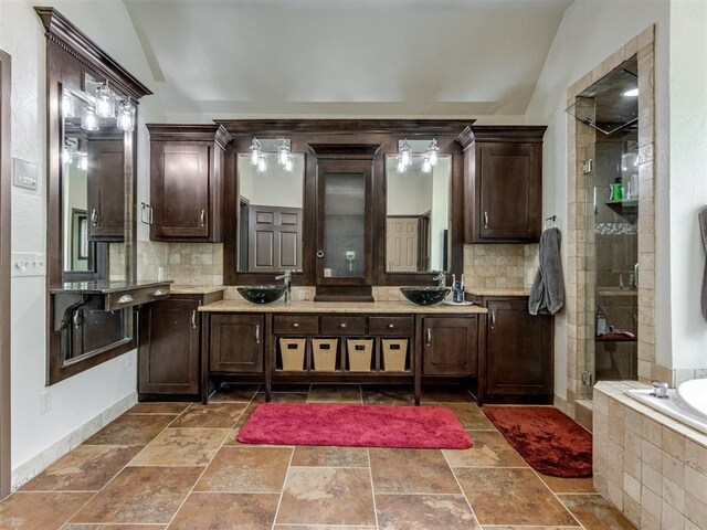 9408 S Caldwell Dr, Midwest City, OK 73130 - bathroom with vaulted ceiling, backsplash, a stall shower, a bath, and double vanity