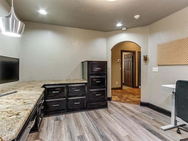 9408 S Caldwell Dr, Midwest City, OK 73130 - bar area featuring arched walkways, light wood-type flooring, and baseboards