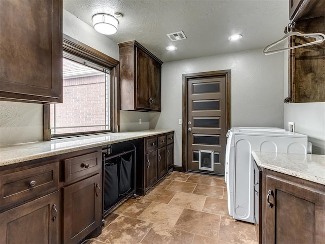 9408 S Caldwell Dr, Midwest City, OK 73130 - laundry area with cabinet space, washer / dryer, and light stone finish floors