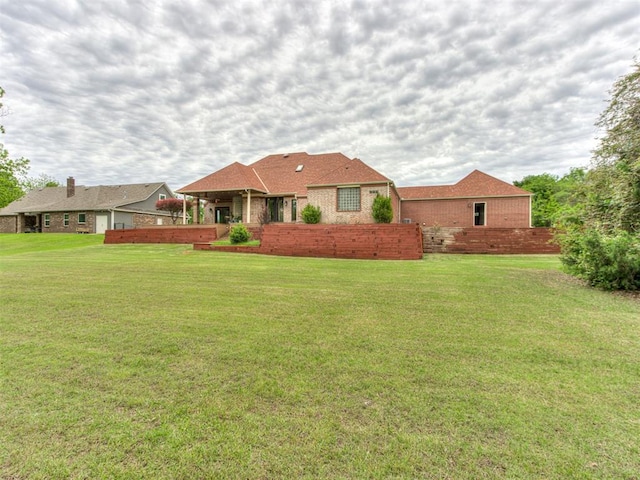 9408 S Caldwell Dr, Midwest City, OK 73130 - rear view of house featuring a yard and brick siding