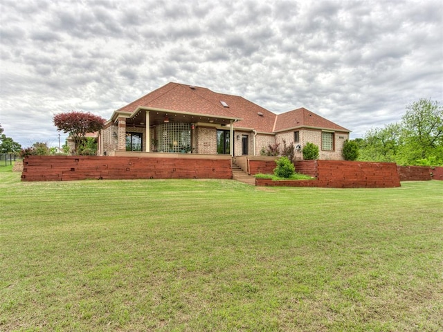 9408 S Caldwell Dr, Midwest City, OK 73130 - rear view of house with brick siding, a lawn, and roof with shingles