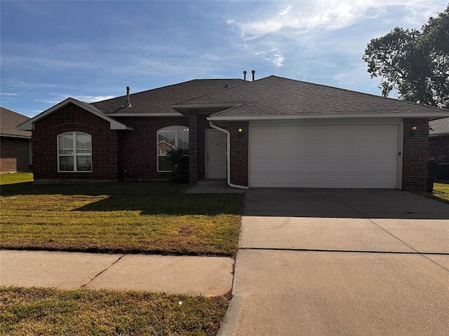 single story home featuring brick siding, driveway, a garage, a front lawn, and a shingled roof