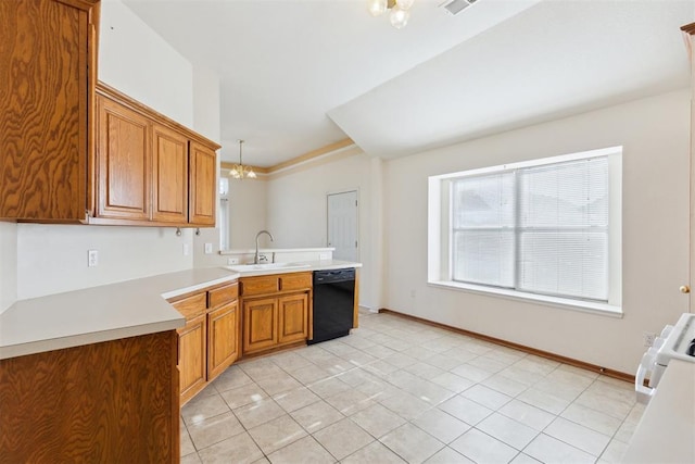 kitchen featuring a notable chandelier, dishwasher, a sink, a peninsula, and brown cabinets