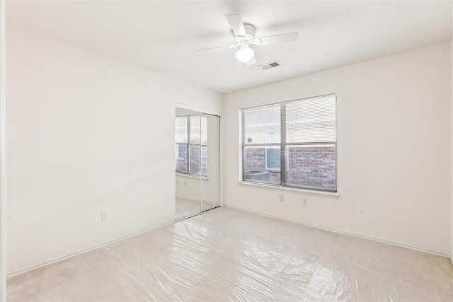 unfurnished room featuring a ceiling fan and visible vents