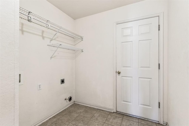 clothes washing area featuring laundry area, baseboards, and hookup for an electric dryer
