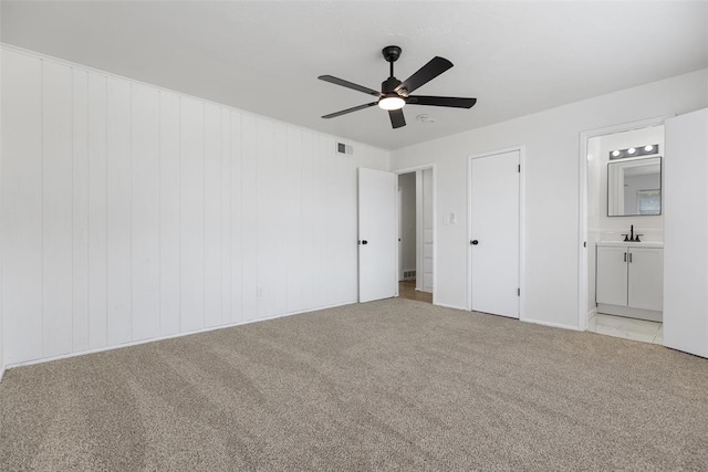3601 N Terry Ave, Oklahoma City, OK 73111 - unfurnished bedroom featuring a ceiling fan, visible vents, a sink, connected bathroom, and light carpet