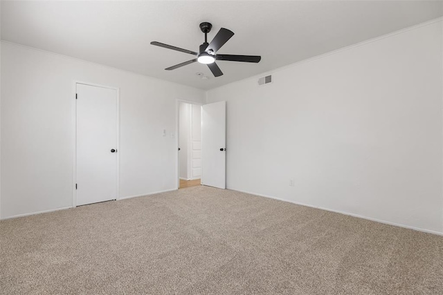 3601 N Terry Ave, Oklahoma City, OK 73111 - unfurnished bedroom with light carpet, baseboards, a ceiling fan, and visible vents