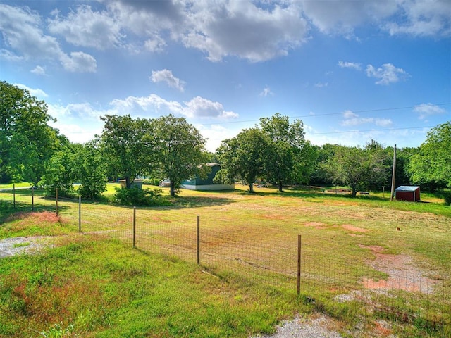 surrounding community with a yard, an outbuilding, a shed, and fence