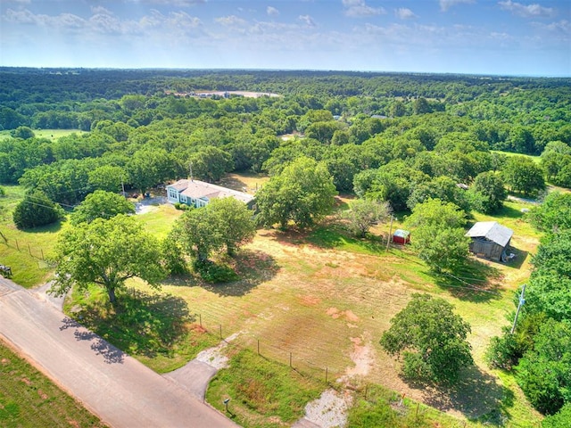 birds eye view of property with a view of trees