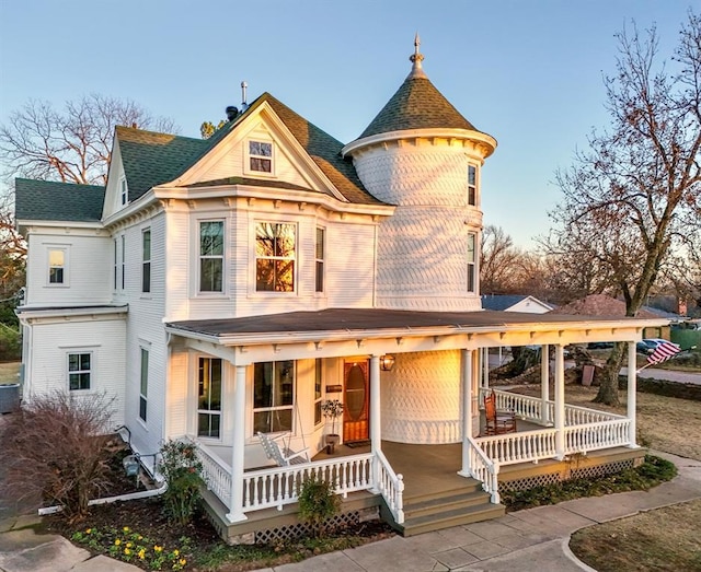 1801 N Broadway Ave, Shawnee, OK 74804 - victorian-style house featuring cooling unit, roof with shingles, and covered porch