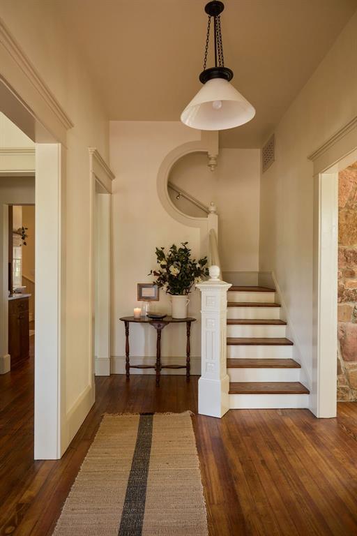 1801 N Broadway Ave, Shawnee, OK 74804 - stairs with visible vents, wood finished floors, and baseboards