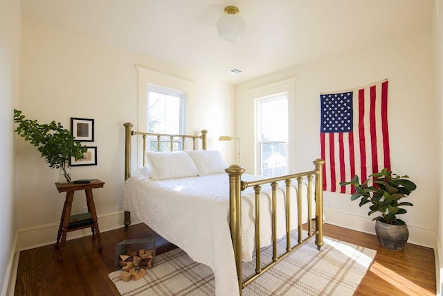 1801 N Broadway Ave, Shawnee, OK 74804 - bedroom featuring baseboards, visible vents, and wood finished floors