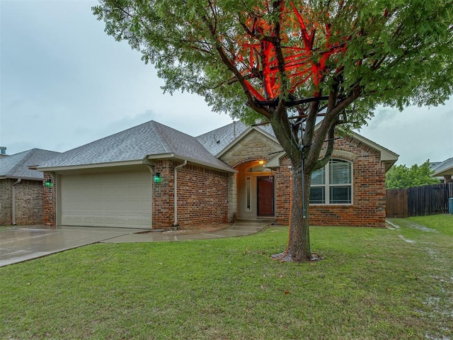 7705 Twin Oaks Dr, Yukon, OK 73099 - view of front facade with a garage, brick siding, driveway, and roof with shingles