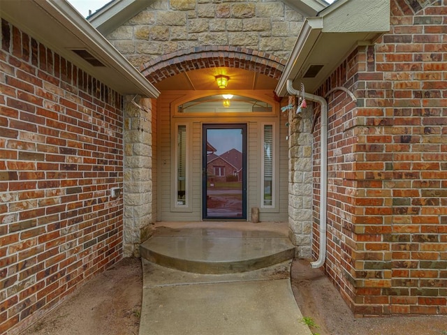 7705 Twin Oaks Dr, Yukon, OK 73099 - doorway to property featuring brick siding and stone siding