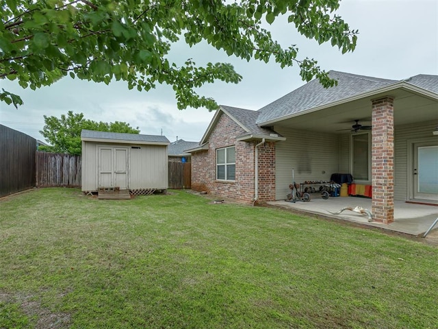 7705 Twin Oaks Dr, Yukon, OK 73099 - view of yard featuring a ceiling fan, a patio area, a storage shed, and an outbuilding