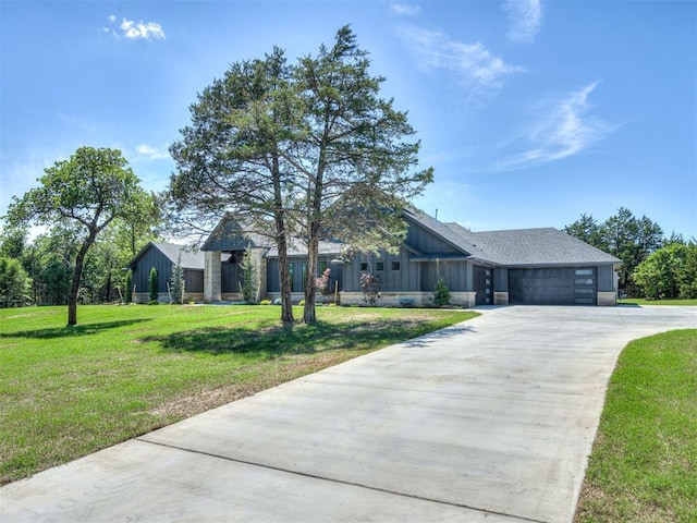 single story home with board and batten siding, a garage, concrete driveway, and a front lawn
