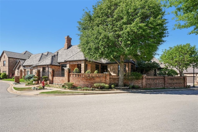 368 Millbrook Dr, Norman, OK 73072 - view of front of property with brick siding, a chimney, fence, and a high end roof