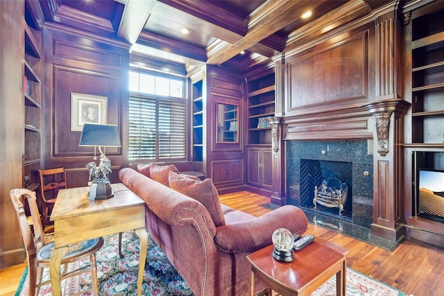 368 Millbrook Dr, Norman, OK 73072 - living area with built in shelves, ornamental molding, wood finished floors, a premium fireplace, and beamed ceiling