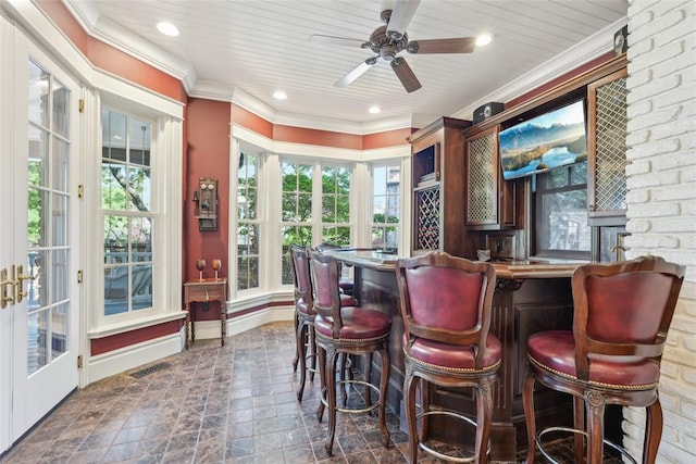 368 Millbrook Dr, Norman, OK 73072 - indoor bar featuring a ceiling fan, dark stone finish flooring, ornamental molding, recessed lighting, and baseboards