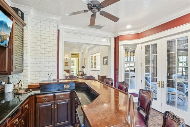 368 Millbrook Dr, Norman, OK 73072 - bar area with brick wall, crown molding, a sink, a ceiling fan, and healthy amount of natural light