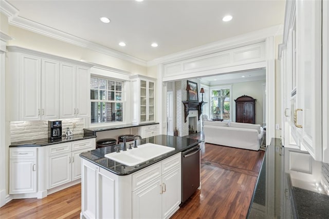 368 Millbrook Dr, Norman, OK 73072 - kitchen with ornamental molding, white cabinetry, stainless steel dishwasher, wood finished floors, and a sink