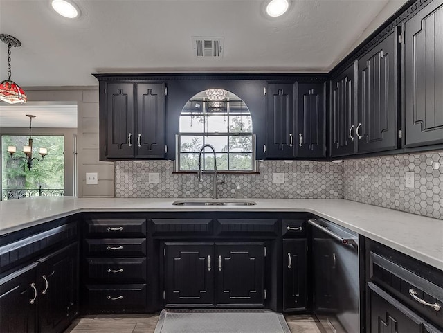 kitchen featuring stainless steel dishwasher, a sink, backsplash, dark cabinets, and recessed lighting