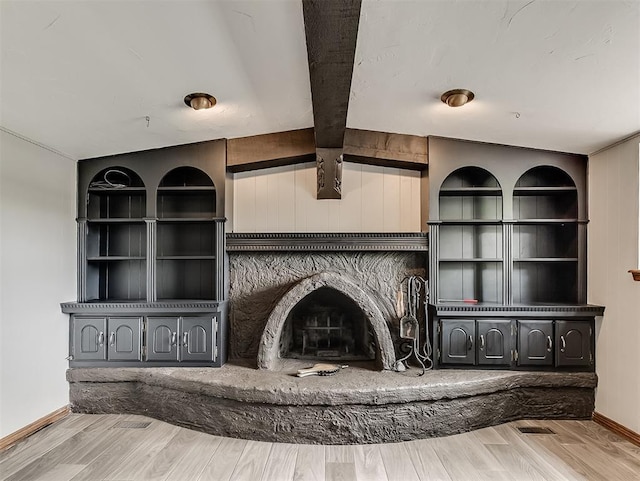 unfurnished living room with wood finished floors and beam ceiling