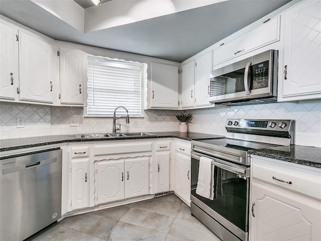 7700 Wegner Way, Oklahoma City, OK 73162 - kitchen featuring stainless steel appliances, a sink, white cabinets, and dark stone countertops
