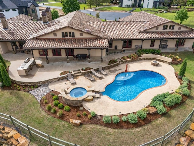 9639 Horizon Cir, Sperry, OK 74073 - view of pool featuring a patio, an outdoor fire pit, a pool with connected hot tub, exterior kitchen, and a fenced backyard
