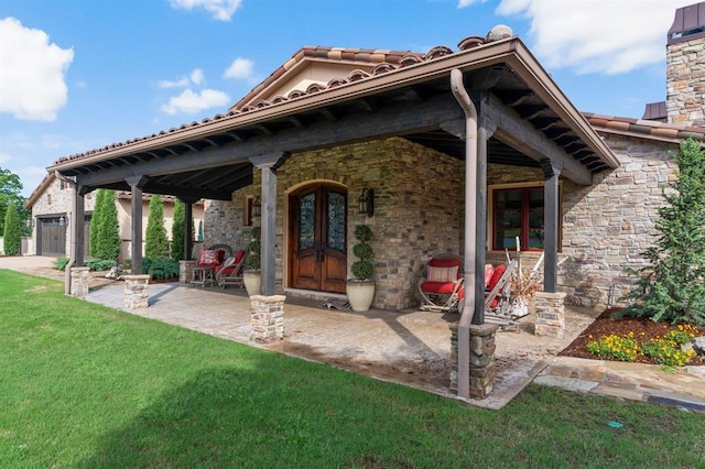 9639 Horizon Cir, Sperry, OK 74073 - doorway to property with a tiled roof, stone siding, and a lawn