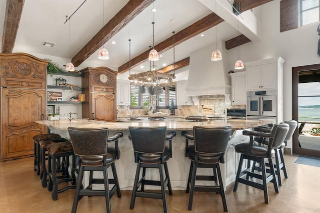 9639 Horizon Cir, Sperry, OK 74073 - kitchen with visible vents, finished concrete floors, decorative backsplash, stainless steel appliances, and beam ceiling