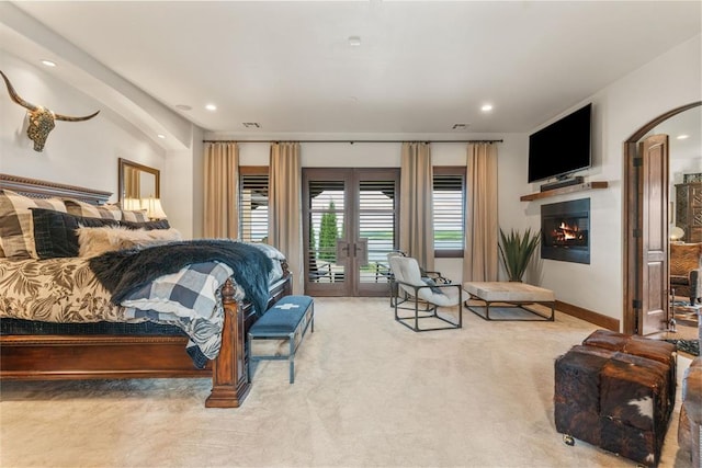 9639 Horizon Cir, Sperry, OK 74073 - bedroom featuring french doors, recessed lighting, carpet floors, access to outside, and a glass covered fireplace