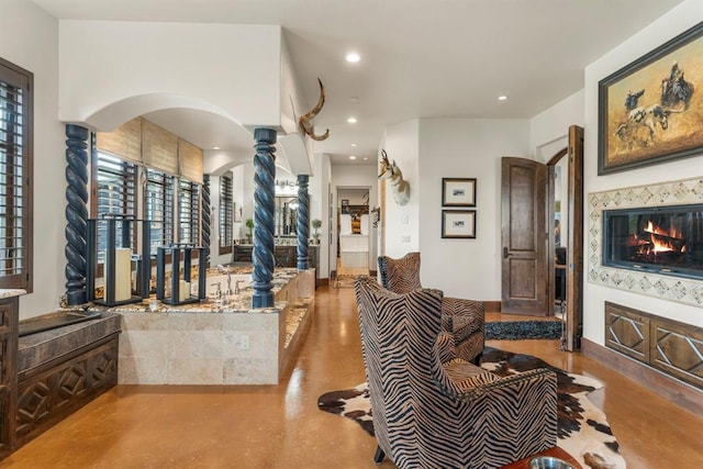 9639 Horizon Cir, Sperry, OK 74073 - interior space with arched walkways, ornate columns, recessed lighting, and concrete flooring