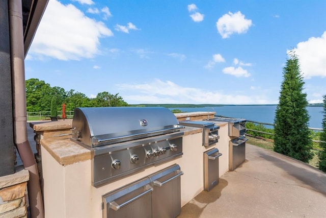 9639 Horizon Cir, Sperry, OK 74073 - view of patio / terrace featuring exterior kitchen, a water view, and a grill