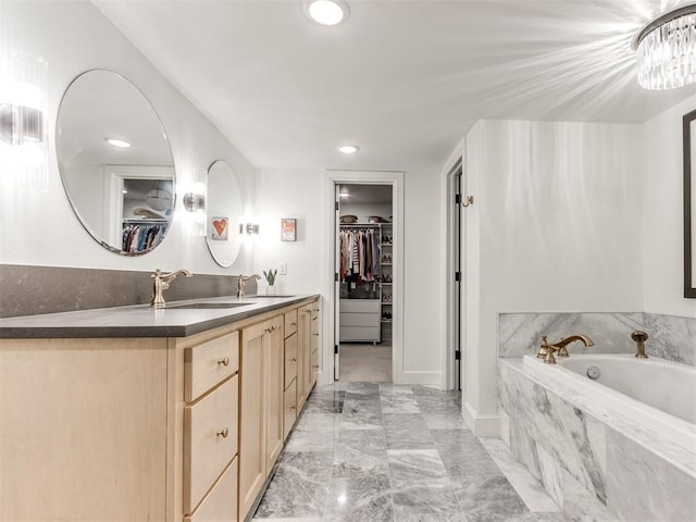 11825 Leaning Elm Rd, Oklahoma City, OK 73120 - bathroom with double vanity, a spacious closet, a bath, marble finish flooring, and recessed lighting