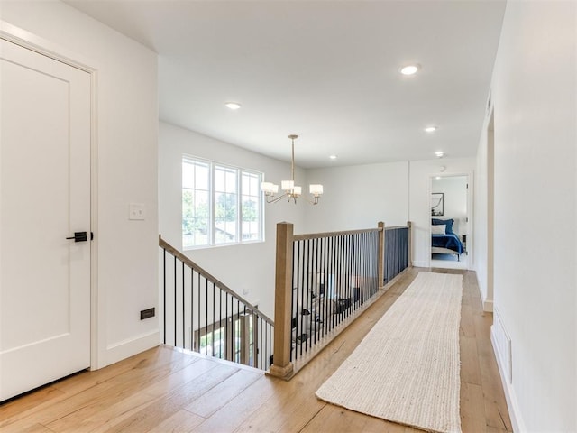 11825 Leaning Elm Rd, Oklahoma City, OK 73120 - hallway featuring a chandelier, hardwood / wood-style flooring, an upstairs landing, and recessed lighting