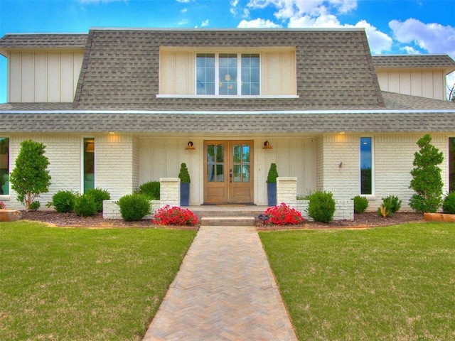 11825 Leaning Elm Rd, Oklahoma City, OK 73120 - view of front property featuring roof with shingles, covered porch, brick siding, and a front yard