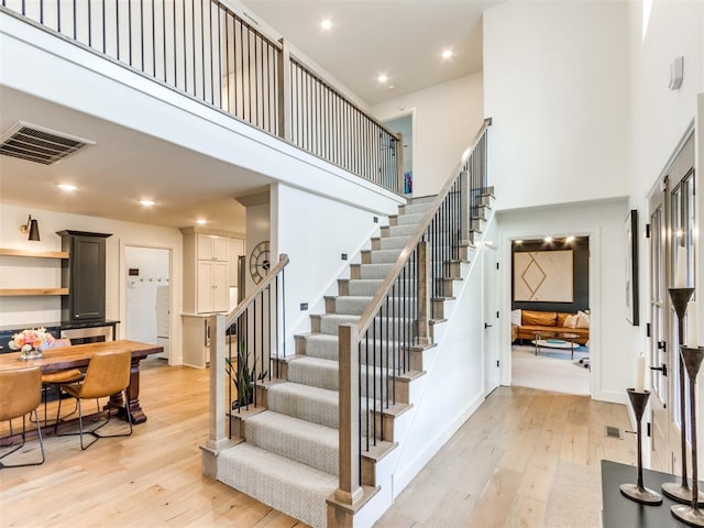 11825 Leaning Elm Rd, Oklahoma City, OK 73120 - stairway with a towering ceiling, hardwood / wood-style floors, and recessed lighting