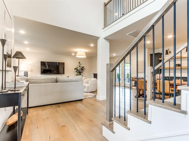 11825 Leaning Elm Rd, Oklahoma City, OK 73120 - living area with wood finished floors, stairs, and recessed lighting
