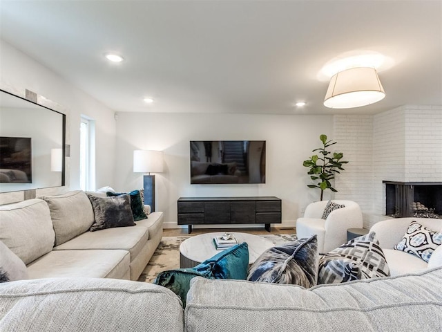 11825 Leaning Elm Rd, Oklahoma City, OK 73120 - living room featuring recessed lighting, a brick fireplace, and wood finished floors