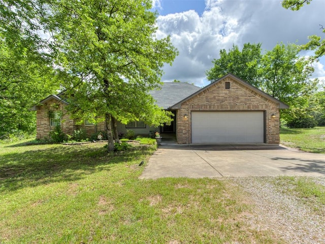 20140 N Rolling Meadows Dr, Luther, OK 73054 - view of front facade with driveway, an attached garage, a front lawn, and brick siding