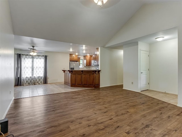 20140 N Rolling Meadows Dr, Luther, OK 73054 - unfurnished living room with a ceiling fan, high vaulted ceiling, plenty of natural light, and light wood finished floors