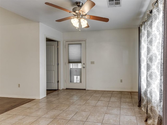 20140 N Rolling Meadows Dr, Luther, OK 73054 - unfurnished room featuring light tile patterned flooring, ceiling fan, and baseboards