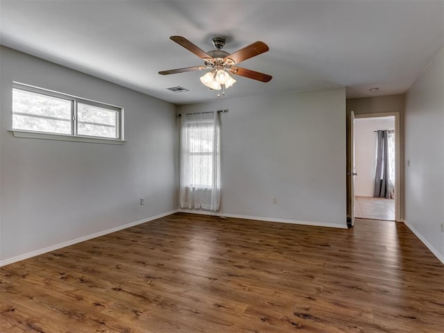 20140 N Rolling Meadows Dr, Luther, OK 73054 - spare room featuring wood finished floors, ceiling fan, and baseboards