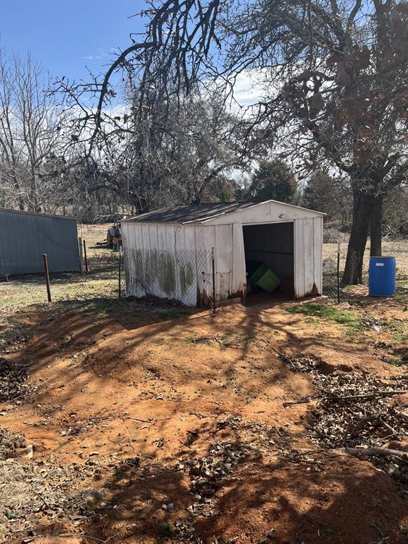 6300 S Hiwassee Rd, Oklahoma City, OK 73150 - view of shed featuring fence
