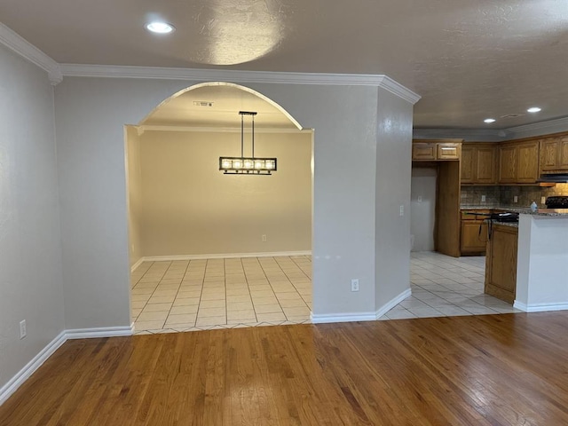 6300 S Hiwassee Rd, Oklahoma City, OK 73150 - unfurnished dining area with light wood-style flooring, arched walkways, ornamental molding, recessed lighting, and baseboards