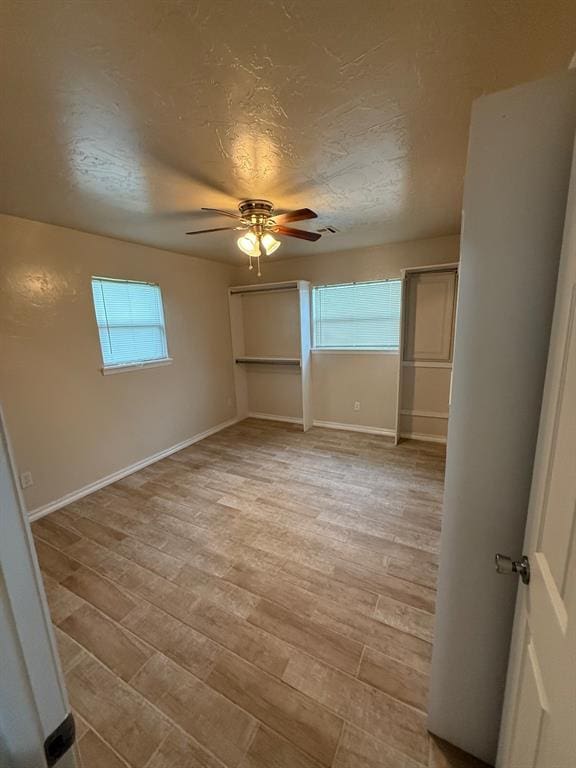 6300 S Hiwassee Rd, Oklahoma City, OK 73150 - spare room with a ceiling fan, light wood-type flooring, and baseboards